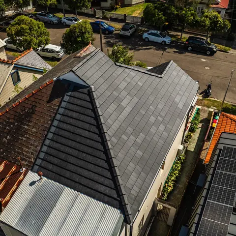 Aerial view of a completed grey residential roof