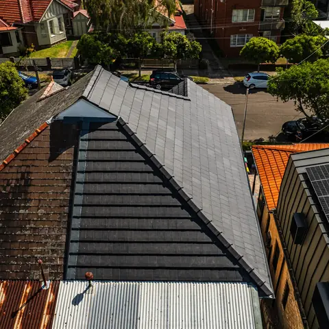 Aerial view of a completed grey residential roof from a second angle