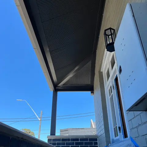 Blue weatherboard home showing finished dark eaves and soffit