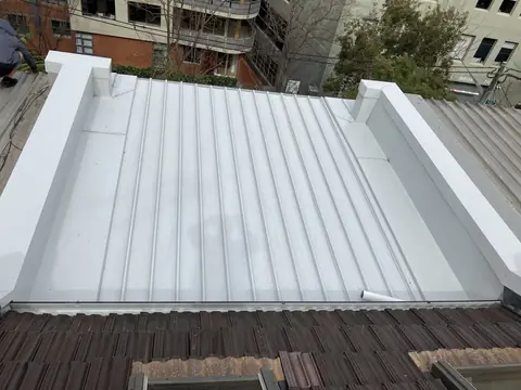 Finished light-coloured Clip-Lok metal roof viewed from above