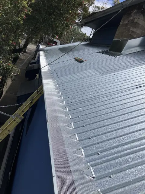 Narrow corrugated metal roof between two sections of a home